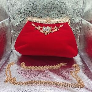 Red Valore clutch purse with gold embellishments